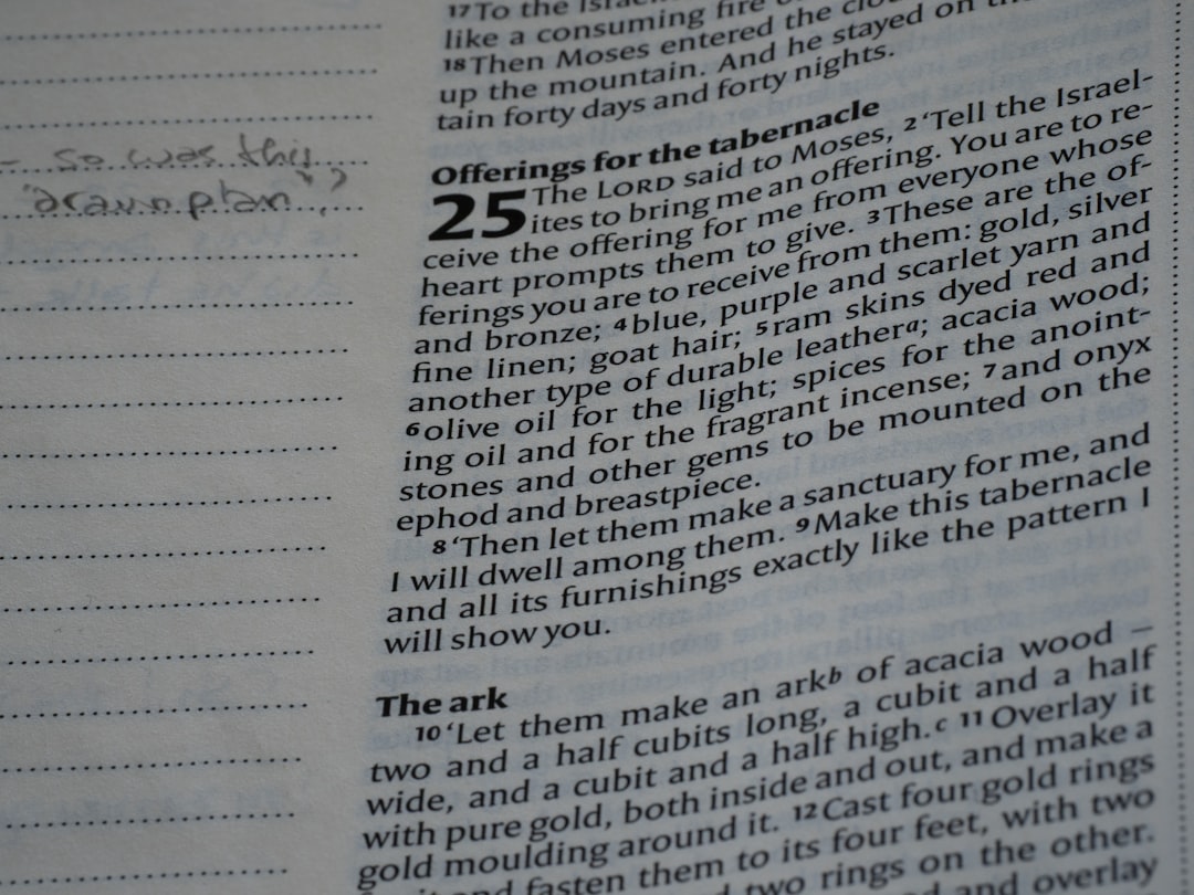 Close-up of an open bible page with text.