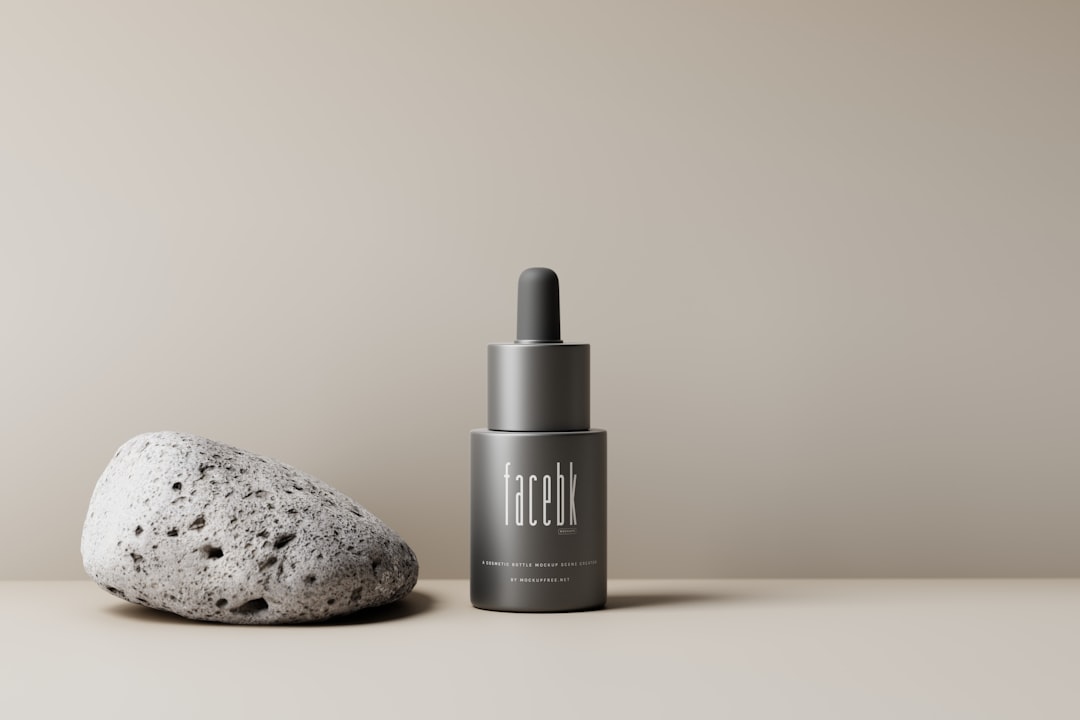 a bottle of liquid next to a rock