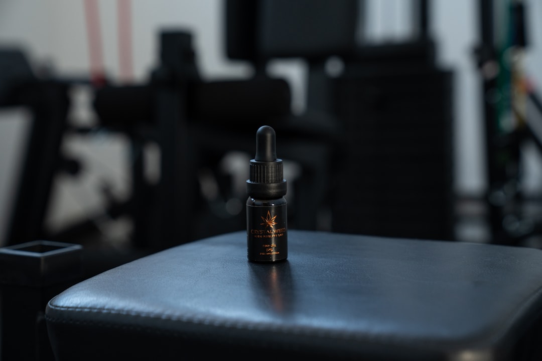 a bottle of essential oil sitting on top of a table
